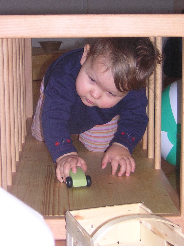 Baby krabbelt durch einen Pikler-Tunnel